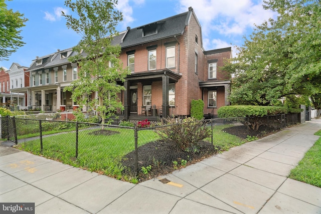 view of front of home with a porch and a front yard