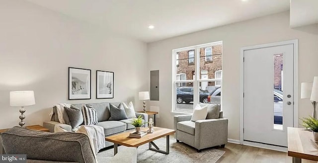 living area with recessed lighting and wood finished floors