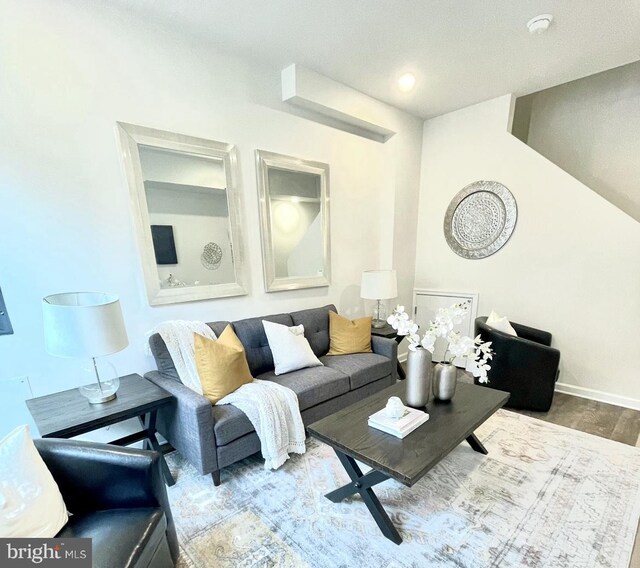 living room with a textured ceiling and hardwood / wood-style floors