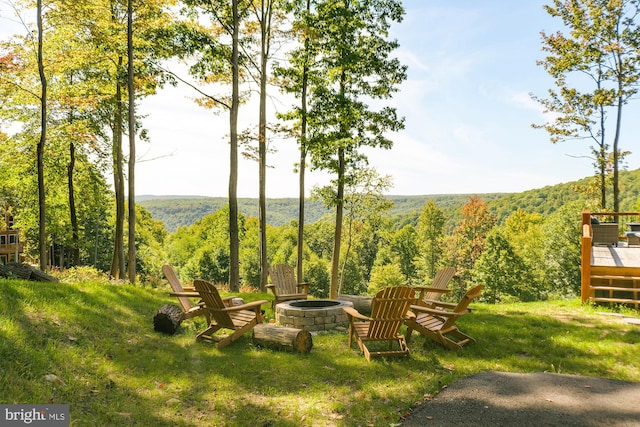 view of yard featuring a wooden deck and an outdoor fire pit