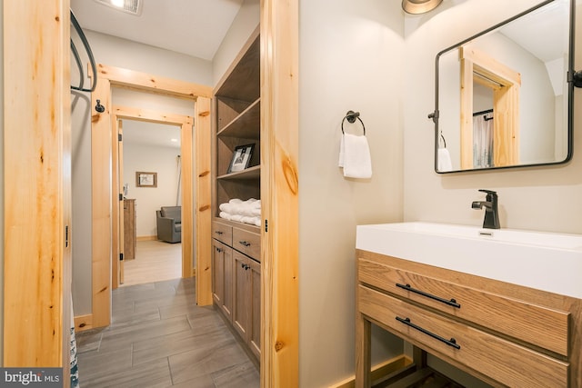 bathroom with vanity and hardwood / wood-style flooring