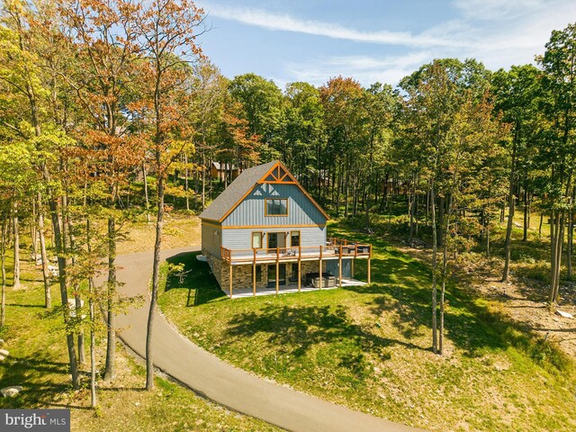 rear view of house featuring a lawn