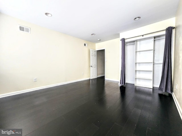 spare room featuring dark hardwood / wood-style flooring