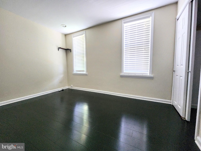 unfurnished room with hardwood / wood-style flooring