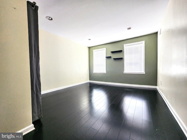 empty room with hardwood / wood-style flooring