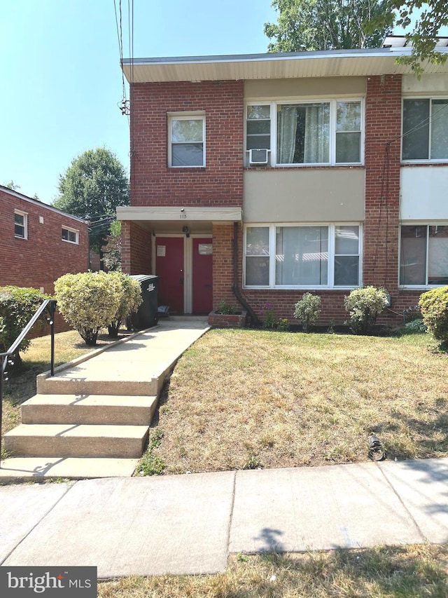 townhome / multi-family property with cooling unit and a garage