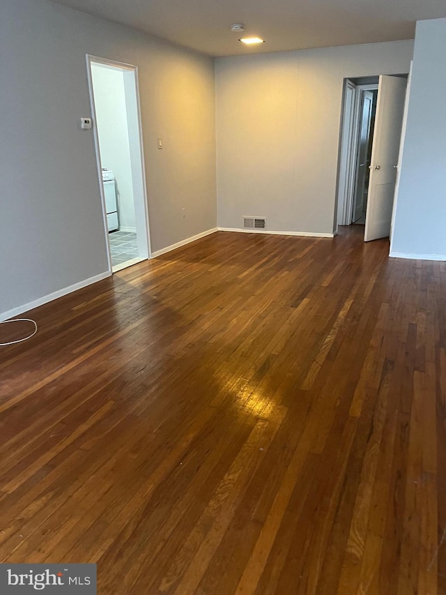 unfurnished room featuring dark hardwood / wood-style flooring