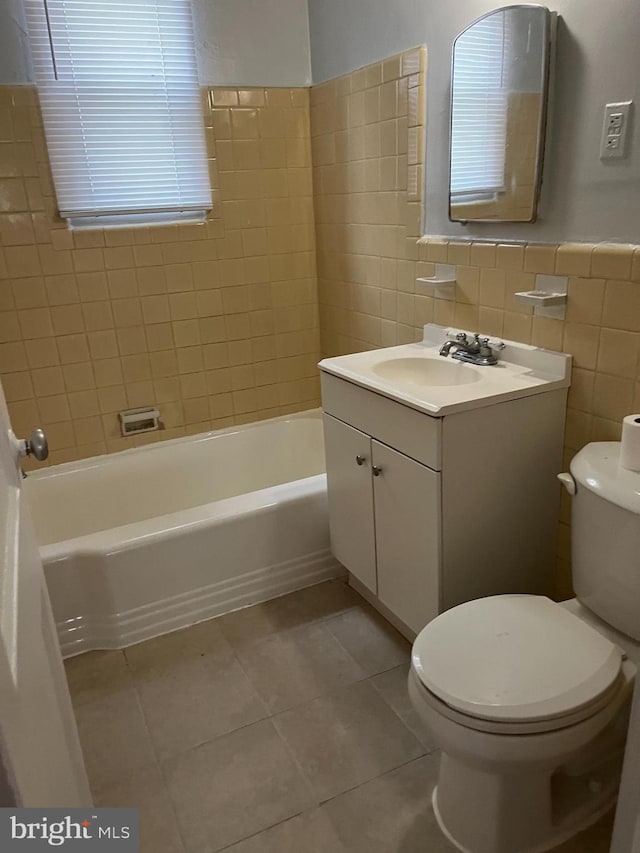 full bathroom with vanity, tile walls, toilet, and tile patterned floors