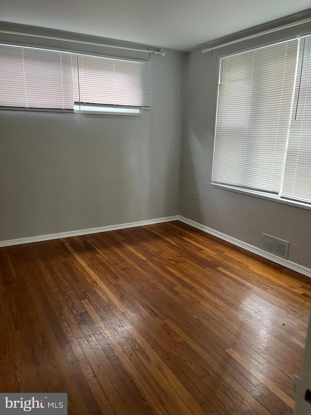 unfurnished room with hardwood / wood-style floors