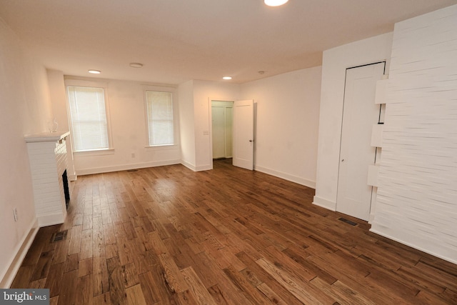 interior space with a fireplace and dark wood-type flooring