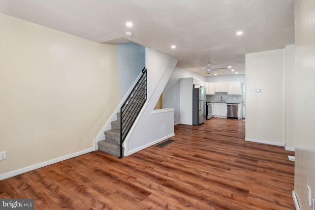 unfurnished living room with ceiling fan and hardwood / wood-style flooring