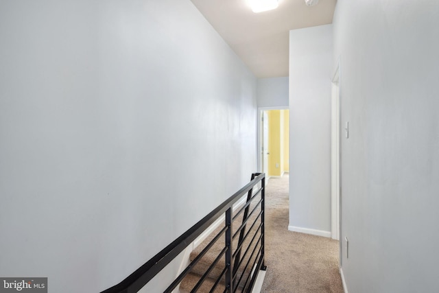 hallway with light colored carpet