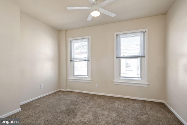 spare room with plenty of natural light, ceiling fan, and carpet