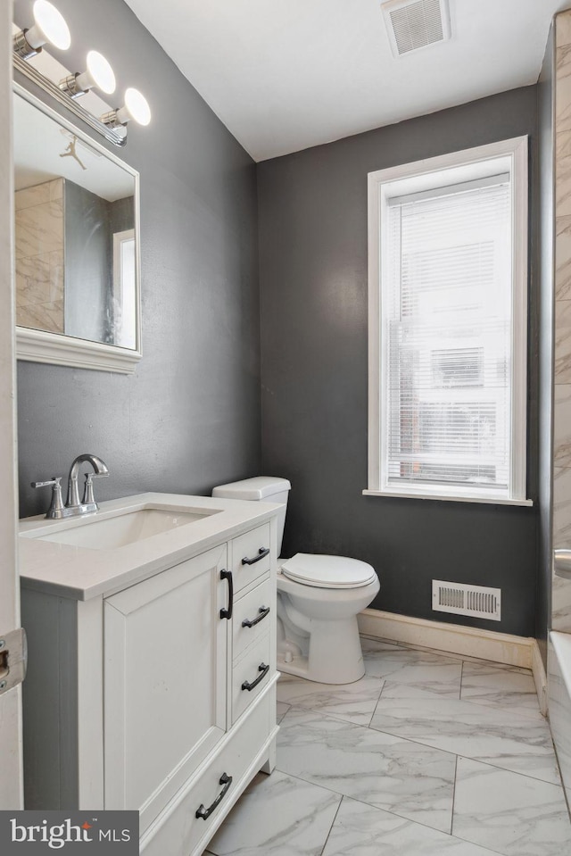 bathroom featuring toilet and vanity