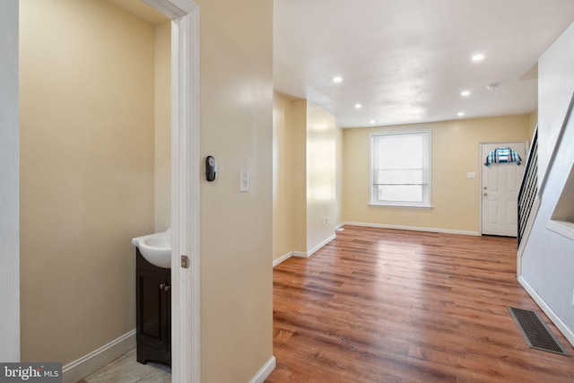 entrance foyer with hardwood / wood-style flooring and sink