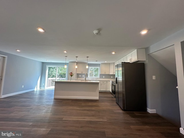 kitchen featuring white cabinets, stainless steel refrigerator, dark wood-type flooring, and a center island