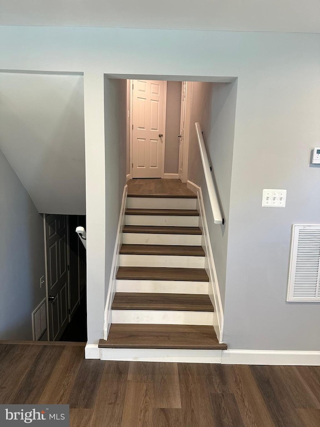 staircase featuring hardwood / wood-style flooring