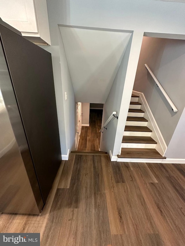 stairs featuring hardwood / wood-style flooring