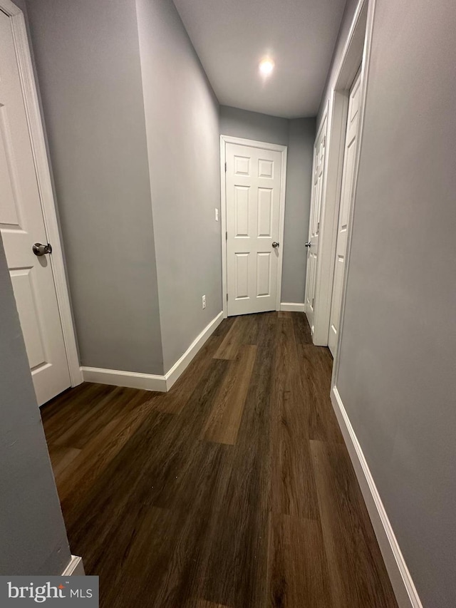 corridor with dark hardwood / wood-style floors