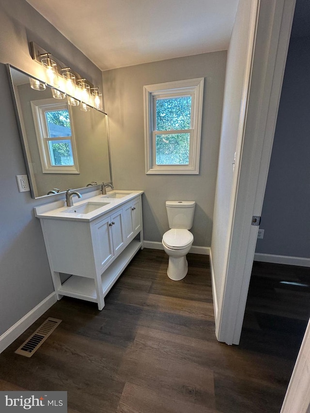 bathroom featuring vanity, toilet, and hardwood / wood-style flooring