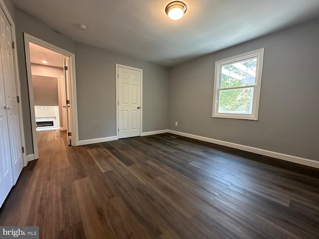 unfurnished bedroom with dark hardwood / wood-style flooring