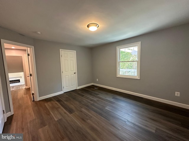 unfurnished bedroom featuring dark hardwood / wood-style flooring