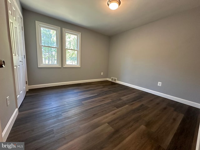 unfurnished room featuring dark hardwood / wood-style floors