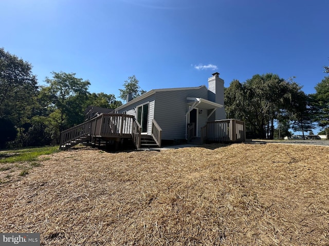 view of side of home featuring a wooden deck