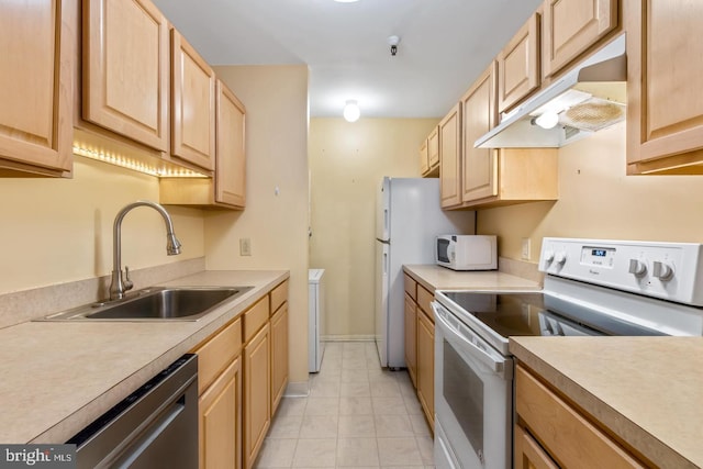 kitchen featuring light brown cabinetry, white appliances, and sink