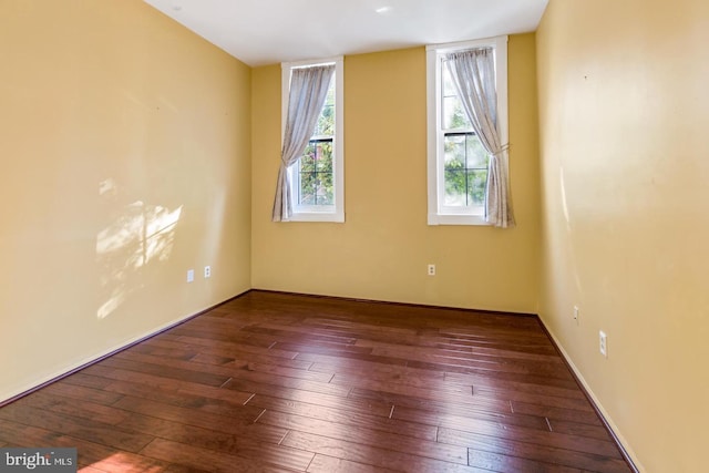 spare room with dark wood-type flooring