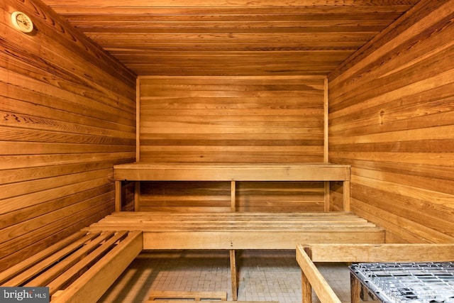 view of sauna / steam room with wood ceiling and wooden walls