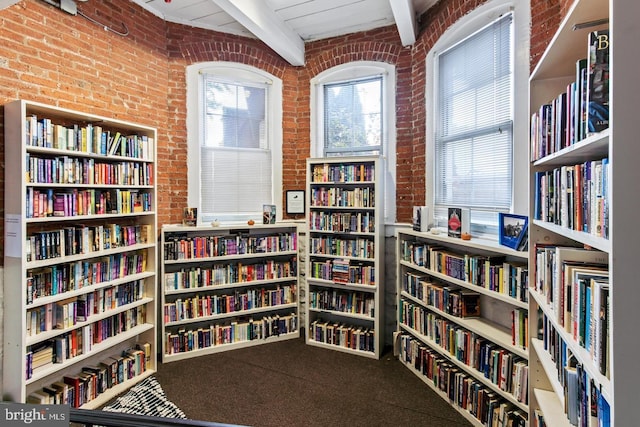 interior space with beam ceiling, brick wall, and wood ceiling