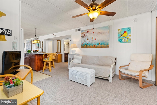 carpeted living room with a textured ceiling and ceiling fan