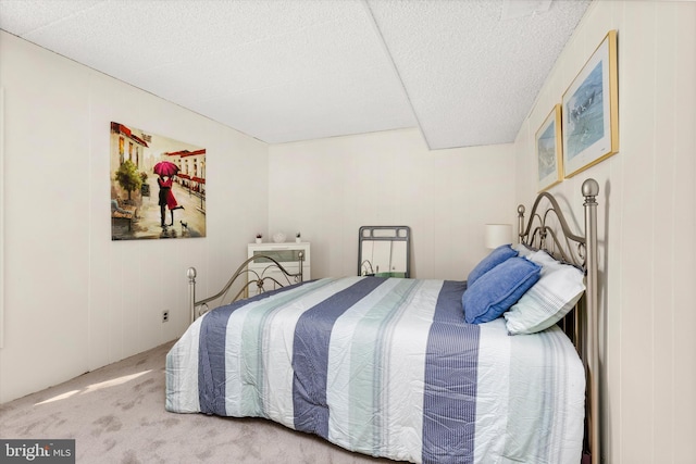 bedroom with a textured ceiling and carpet