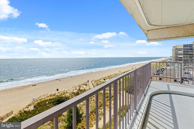 balcony with a beach view and a water view