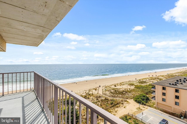 balcony with a beach view and a water view