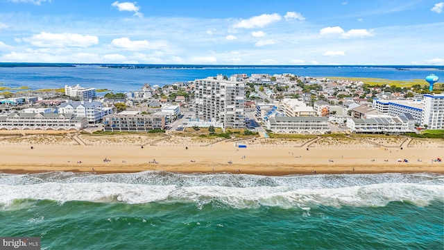 drone / aerial view featuring a beach view and a water view