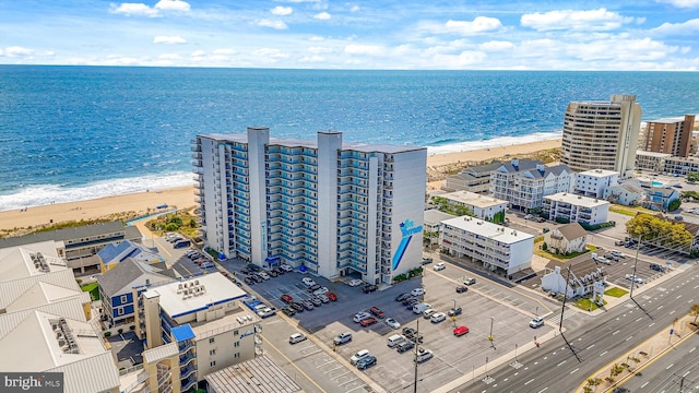 bird's eye view with a water view and a beach view