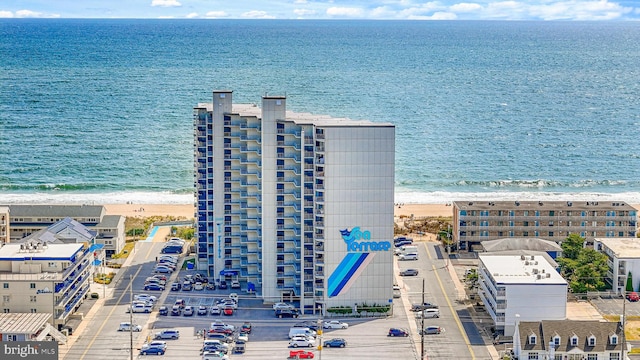 drone / aerial view featuring a water view and a view of the beach