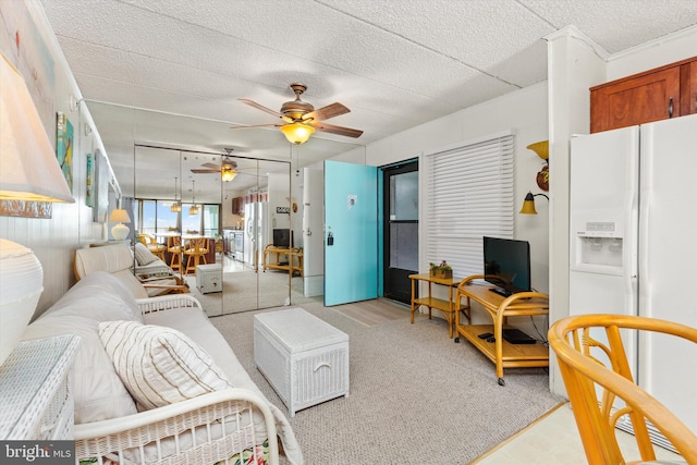 living room with a textured ceiling and ceiling fan