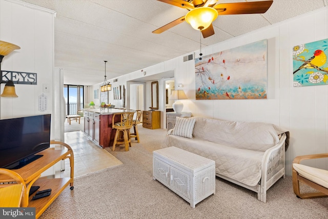 carpeted living room with a textured ceiling and ceiling fan