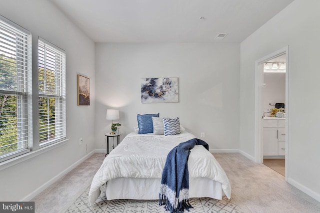 carpeted bedroom featuring connected bathroom