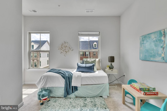 carpeted bedroom featuring multiple windows