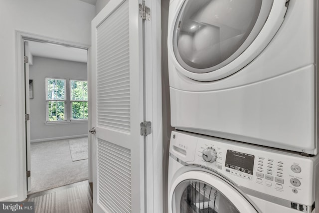 washroom featuring stacked washer and dryer