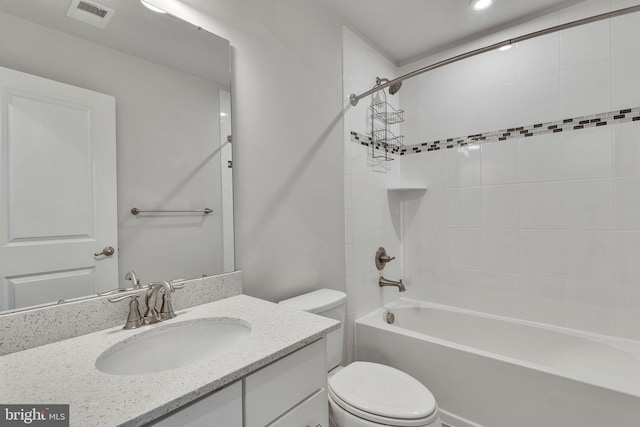 full bathroom with vanity, toilet, and tiled shower / bath