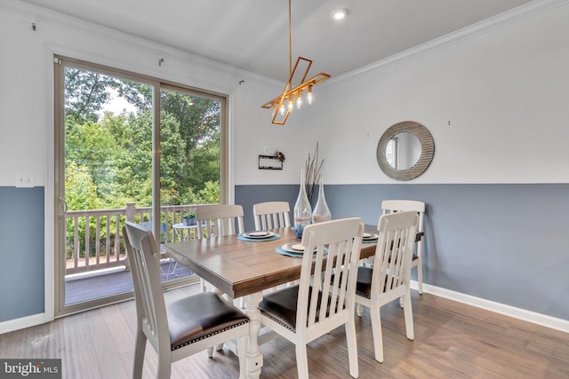 dining area featuring crown molding and hardwood / wood-style flooring