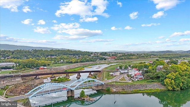 drone / aerial view featuring a water and mountain view