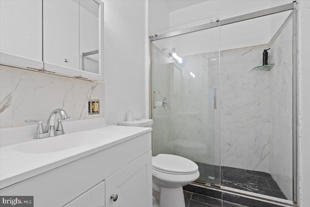 bathroom with a shower with door, tile patterned floors, decorative backsplash, toilet, and vanity