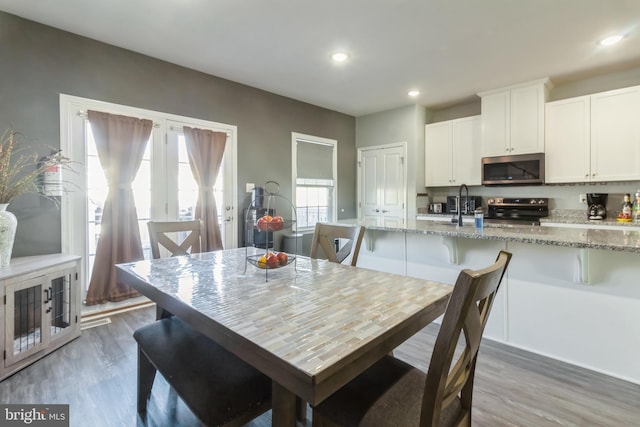 dining room featuring dark hardwood / wood-style flooring and sink