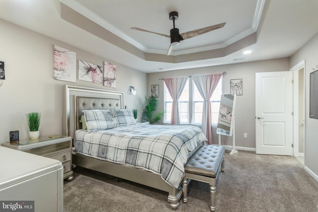 bedroom with ceiling fan, carpet floors, a tray ceiling, and ornamental molding